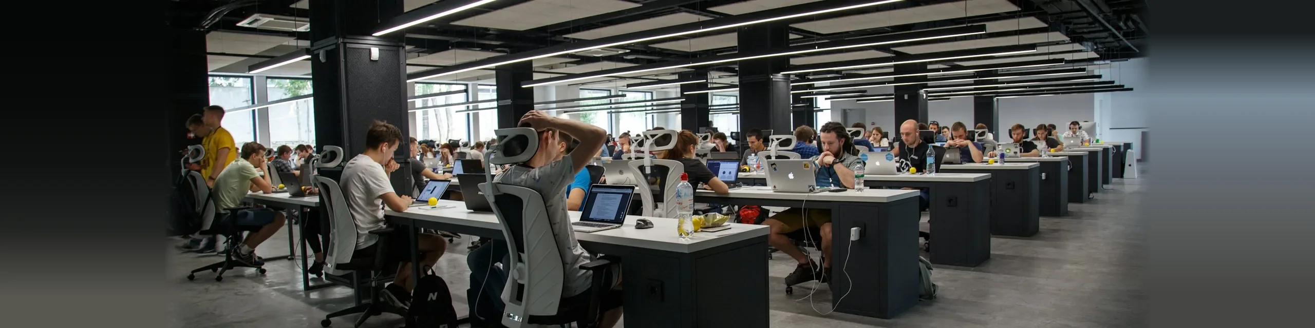 Support and engineering team working across rows of workstations